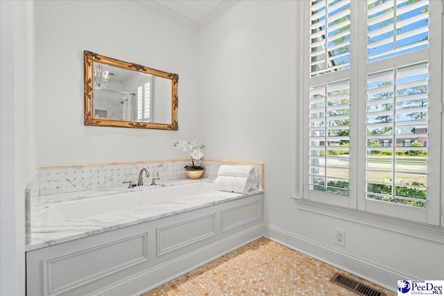 bathroom with plenty of natural light, ornamental molding, baseboards, and visible vents