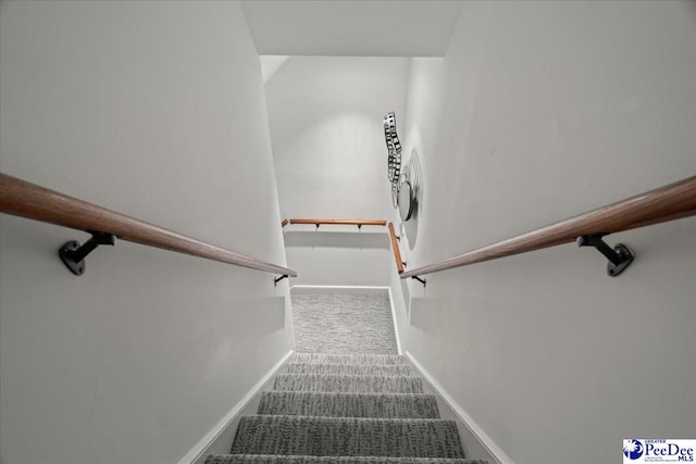 stairway with carpet floors and baseboards