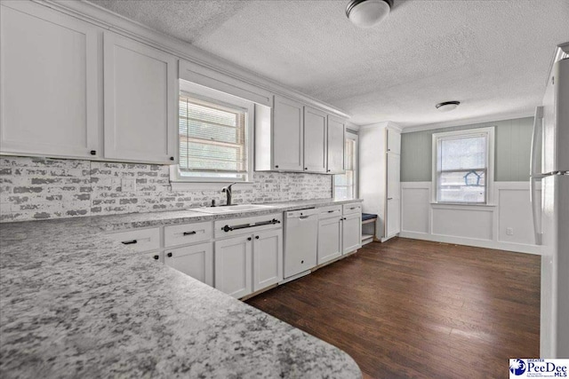 3712 E Hoyt St, Florence, SC 29506 - kitchen with white appliances, a textured ceiling, dark wood-style floors, tasteful backsplash, and light stone counters