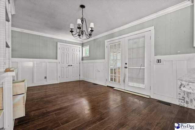 3712 E Hoyt St, Florence, SC 29506 - unfurnished dining area with crown molding, a chandelier, wood-type flooring, french doors, and a textured ceiling