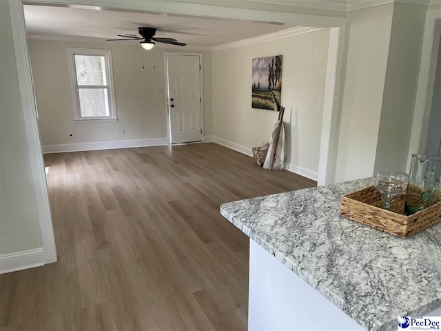 929 E Home Ave, Hartsville, SC 29550 - unfurnished living room featuring baseboards, crown molding, a ceiling fan, and wood finished floors