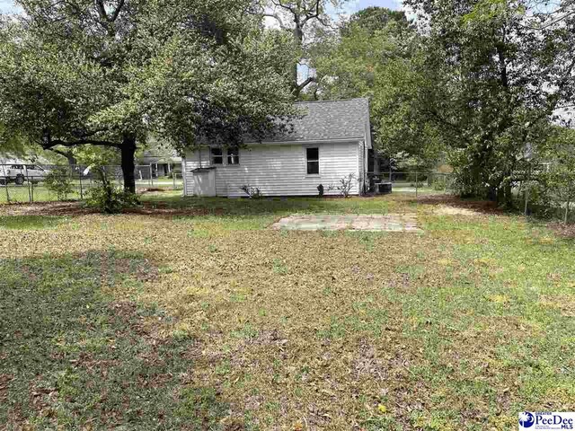 929 E Home Ave, Hartsville, SC 29550 - view of yard featuring central AC unit and fence