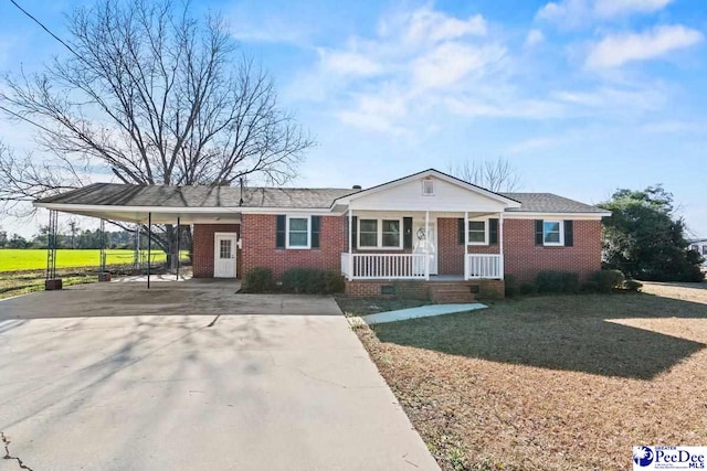 ranch-style house with a carport, covered porch, and a front lawn