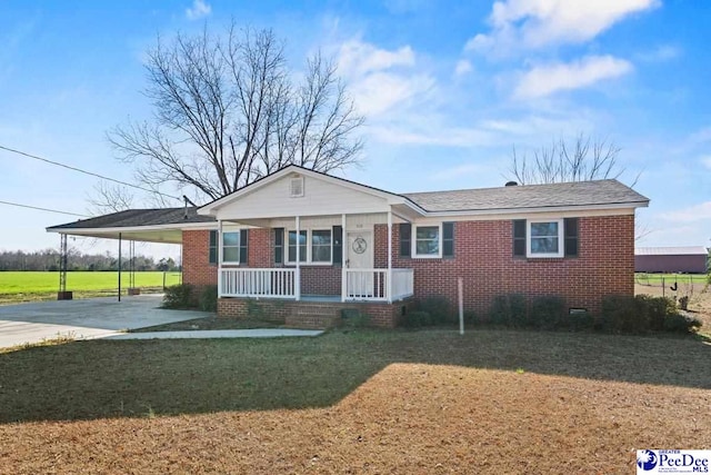 single story home featuring a carport, covered porch, and a front lawn