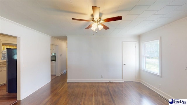 empty room with dark wood-type flooring, ceiling fan, and ornamental molding