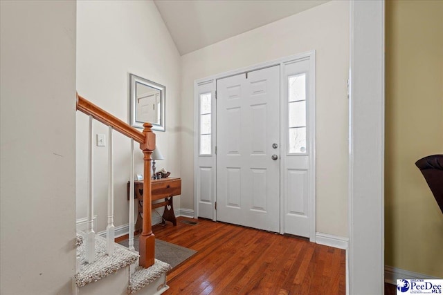 entryway with hardwood / wood-style flooring and lofted ceiling