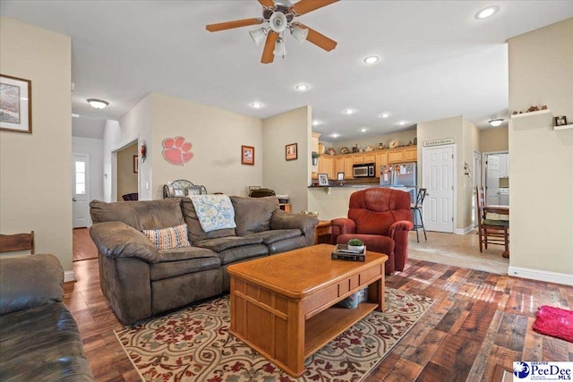 living room featuring ceiling fan and light hardwood / wood-style floors