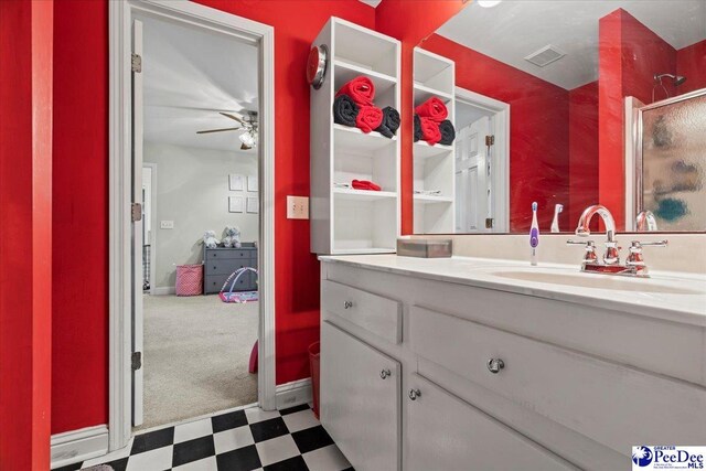 bathroom with vanity, a shower with door, and ceiling fan