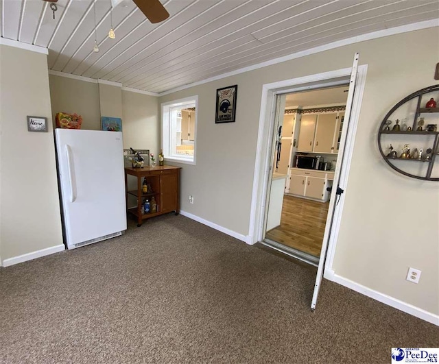 unfurnished room featuring carpet, ceiling fan, wood ceiling, and crown molding