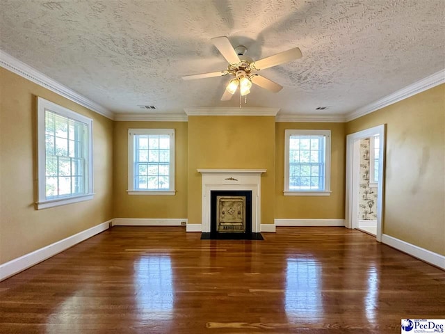 unfurnished living room with crown molding, dark wood-type flooring, and a healthy amount of sunlight