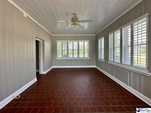 unfurnished sunroom featuring wooden ceiling and ceiling fan