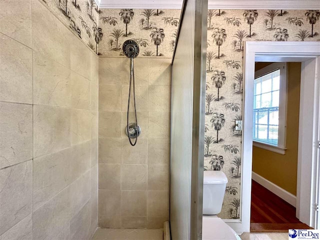 bathroom with tiled shower and toilet