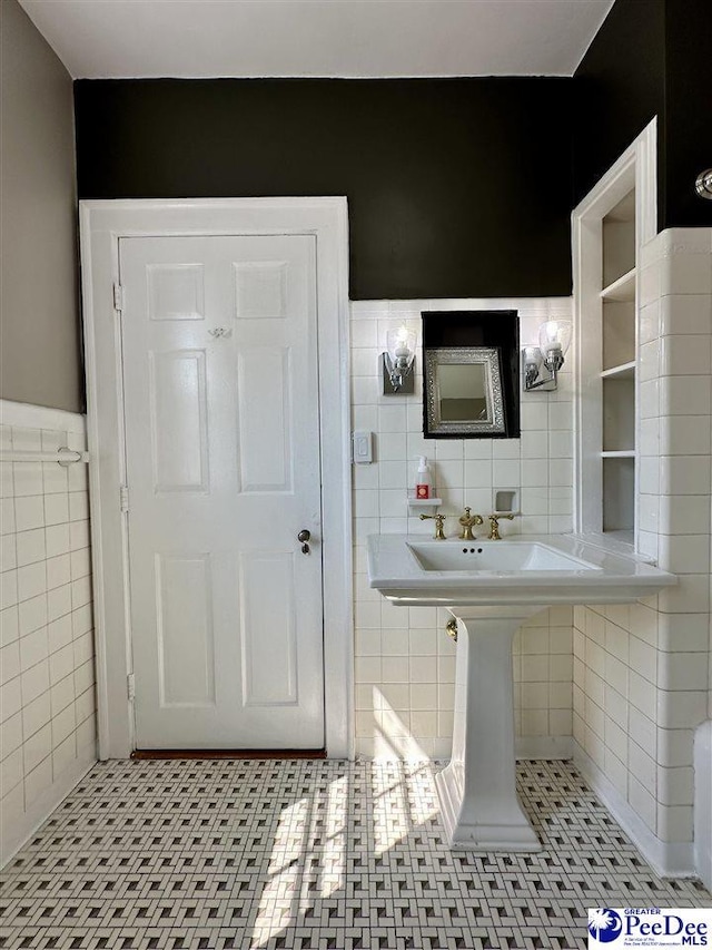 bathroom featuring tile patterned flooring and tile walls