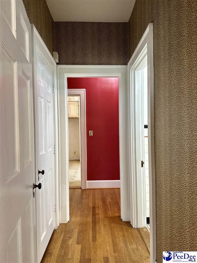 hallway with light hardwood / wood-style floors