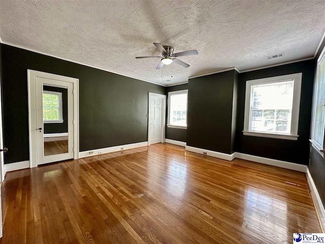 unfurnished room with crown molding, hardwood / wood-style floors, and ceiling fan