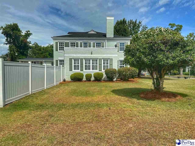 rear view of property with a yard