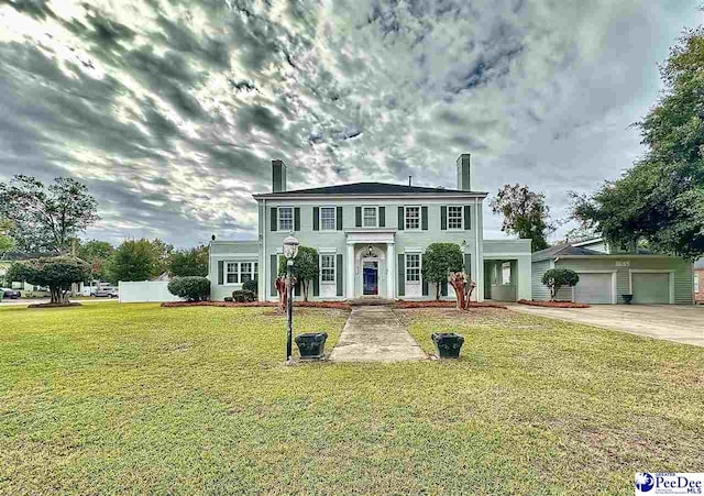 colonial-style house with a garage and a front yard