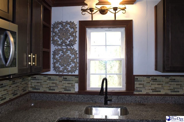 114 Law St, Darlington, SC 29532 - kitchen featuring a sink, dark brown cabinets, stainless steel microwave, and backsplash