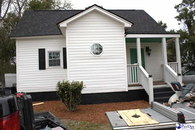 view of property exterior featuring roof with shingles