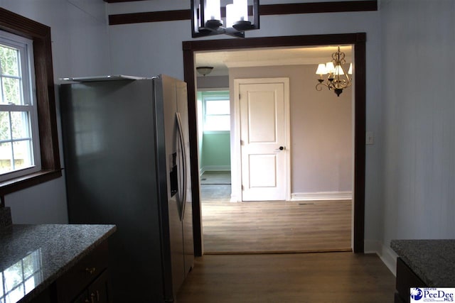 114 Law St, Darlington, SC 29532 - kitchen with stone countertops, stainless steel fridge, a notable chandelier, and wood finished floors