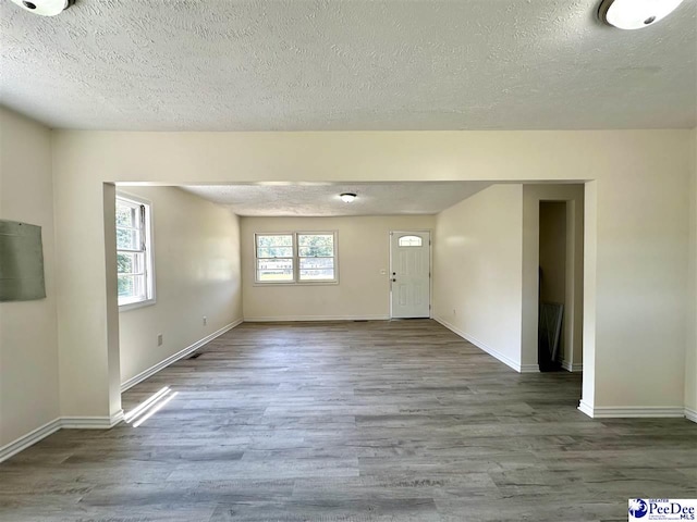 interior space with hardwood / wood-style floors and a textured ceiling