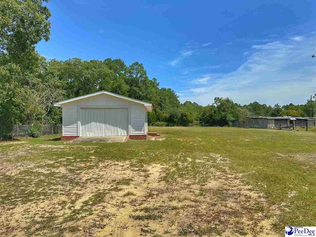 view of yard featuring an outbuilding and a garage