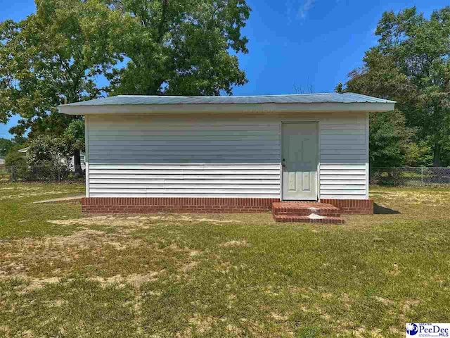 view of outdoor structure featuring a lawn