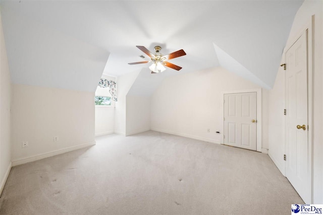 bonus room with light carpet, vaulted ceiling, and ceiling fan