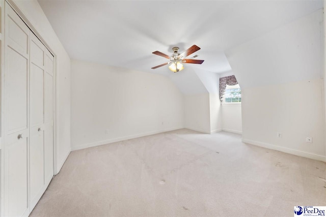 bonus room featuring lofted ceiling, light colored carpet, and ceiling fan