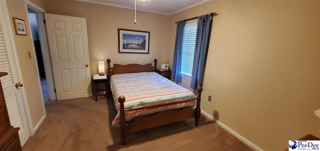 carpeted bedroom with ornamental molding and baseboards