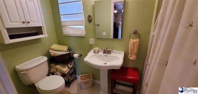 bathroom featuring toilet and tile patterned floors