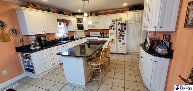 kitchen featuring white appliances, open shelves, a sink, and a center island