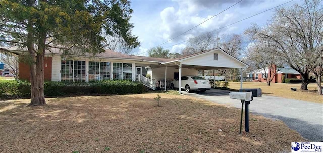 ranch-style home with driveway and an attached carport