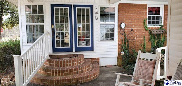 property entrance with brick siding