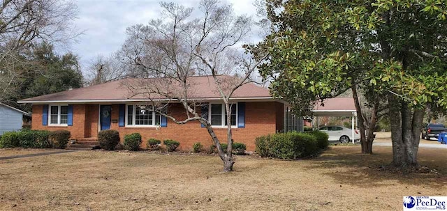 ranch-style home with a carport and brick siding