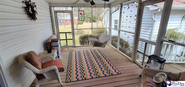 sunroom / solarium featuring ceiling fan