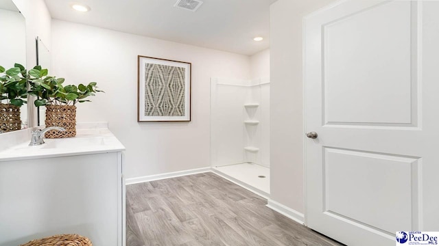 593 Strawberry Field Way, Galivants Ferry, SC 29544 - bathroom with wood finished floors, baseboards, a shower, vanity, and recessed lighting
