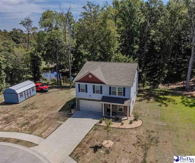 view of front property with a storage shed, a front lawn, a water view, and covered porch