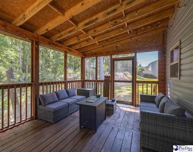 sunroom featuring lofted ceiling