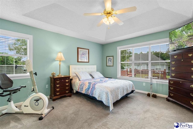 2122 Twin Bridge Dr, Florence, SC 29505 - carpeted bedroom with a ceiling fan, a textured ceiling, and a tray ceiling