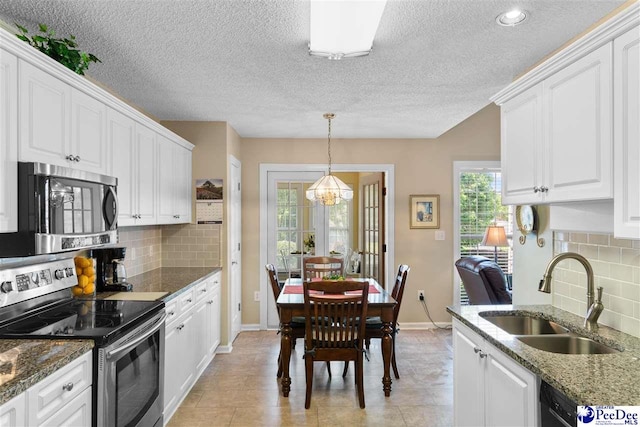 2122 Twin Bridge Dr, Florence, SC 29505 - kitchen featuring stainless steel appliances, white cabinetry, decorative backsplash, a textured ceiling, and dark stone counters