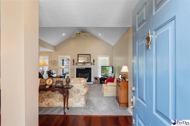 2122 Twin Bridge Dr, Florence, SC 29505 - living room featuring wood finished floors, ceiling fan, lofted ceiling, a high end fireplace, and a textured ceiling