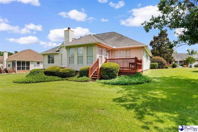 2122 Twin Bridge Dr, Florence, SC 29505 - back of property featuring a wooden deck, a lawn, a sunroom, and a chimney