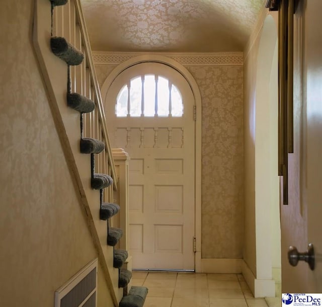 foyer entrance featuring light tile patterned flooring