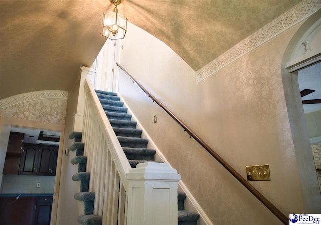 stairs with vaulted ceiling