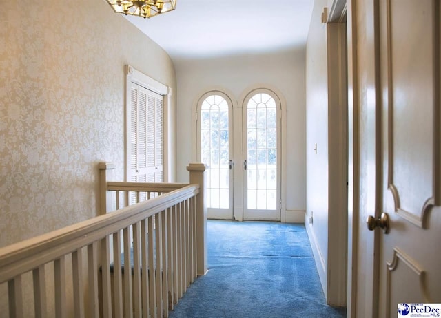 hallway featuring dark colored carpet and french doors