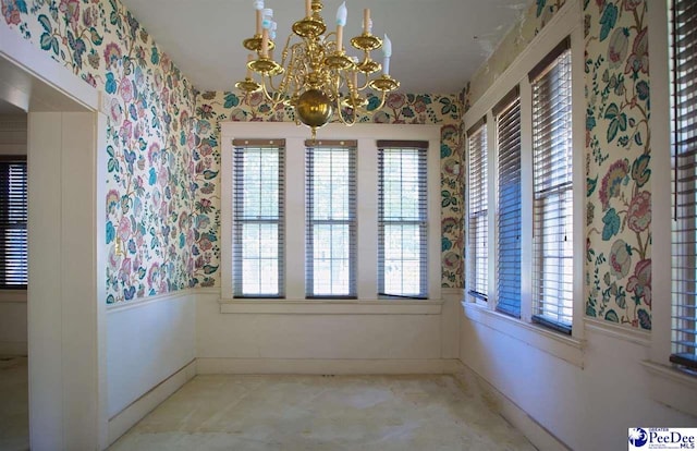 unfurnished dining area featuring a notable chandelier