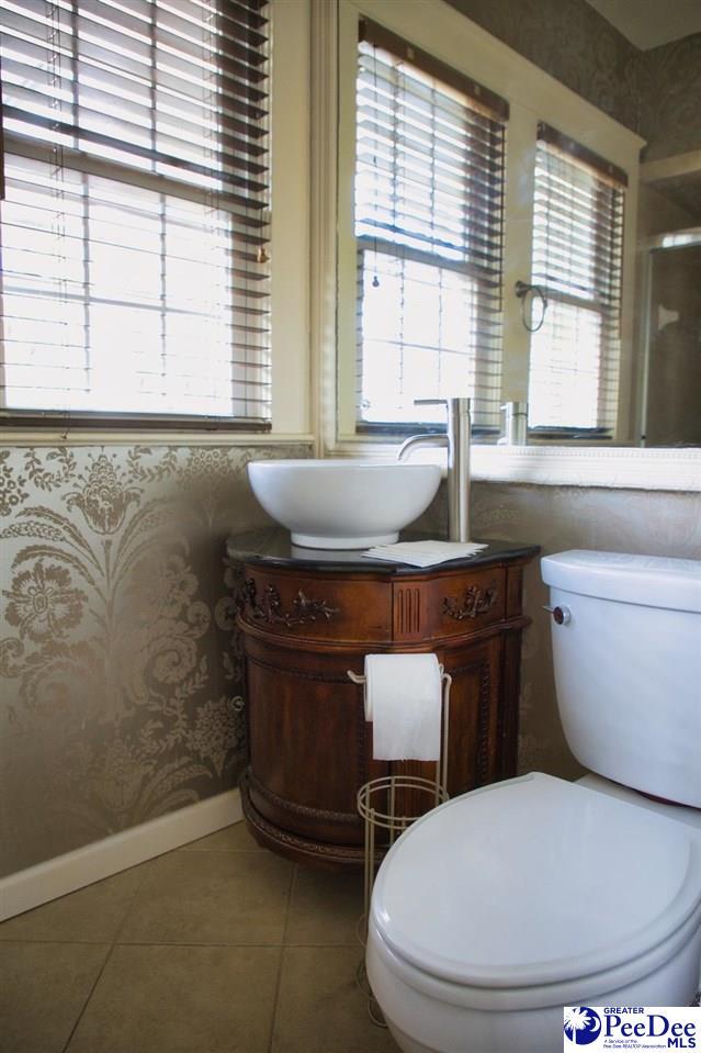 bathroom featuring vanity, tile patterned floors, and toilet