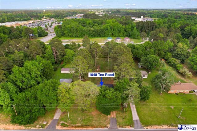 birds eye view of property with a view of trees