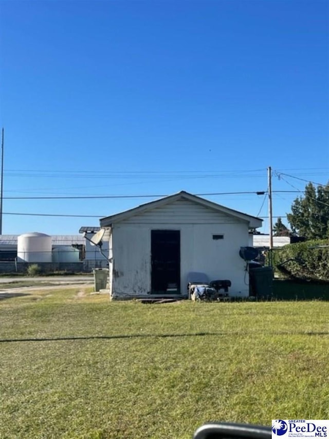 view of outbuilding featuring a yard